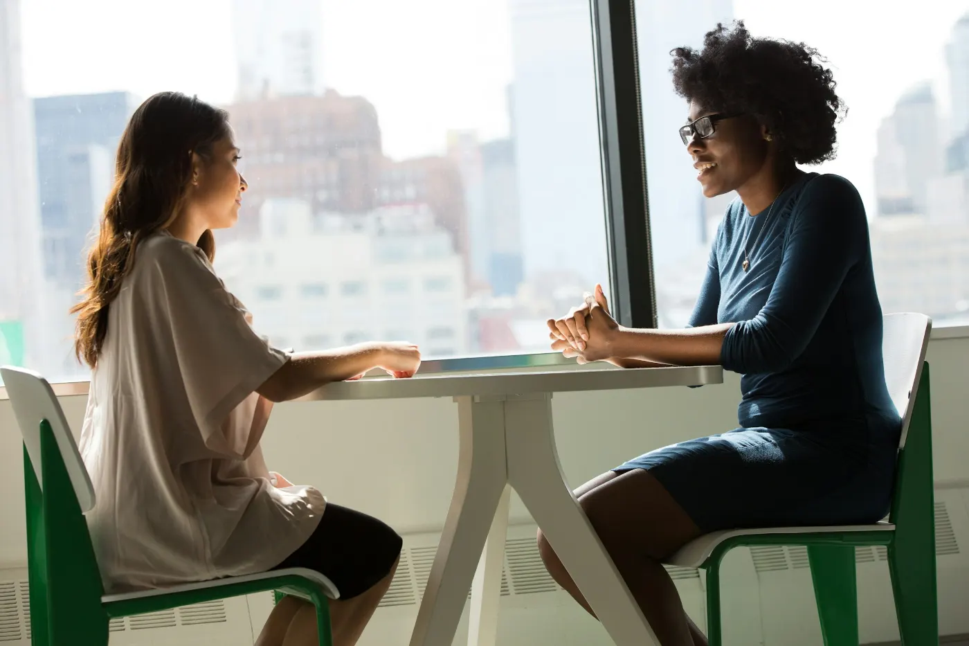 Two women talking across a table during a job interview